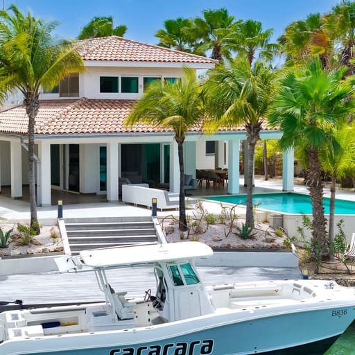 Waterfront villa on Bonaire with a private dock and moored boat